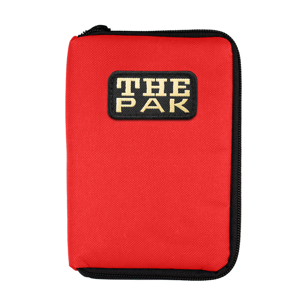 Das Bild zeigt ein rotes Etui mit schwarzem Reißverschluss. Auf der Vorderseite befindet sich ein Aufnäher mit der Aufschrift "THE PAK".